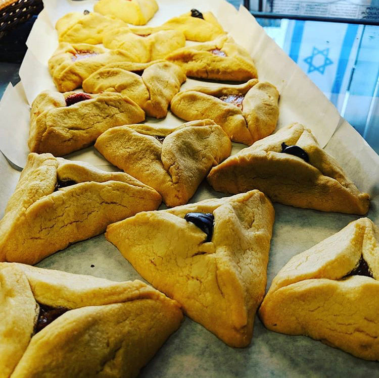 Tray of Kosher Hamentaschen in a variety of fruit filled flavors for Purim